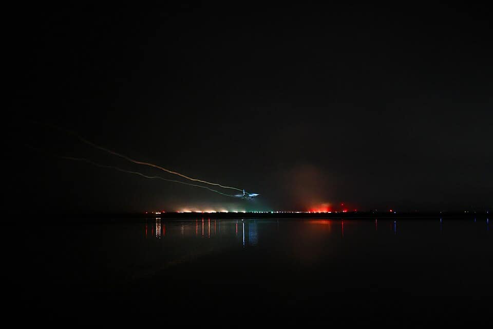 Aircraft landing in fog over runway approach lights