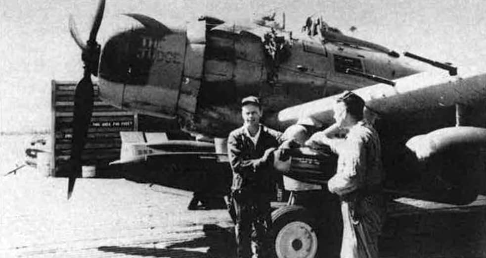 USAF A-1 Skyraider pilots with their aircraft after a successful search and rescue mission in Vietnam, July 1970