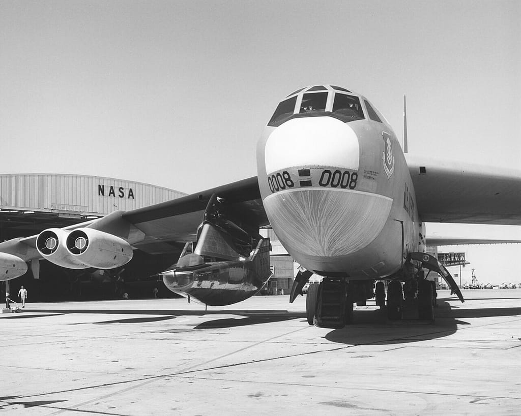 The M2-F2 mounted under the wing of its B-52 mothership