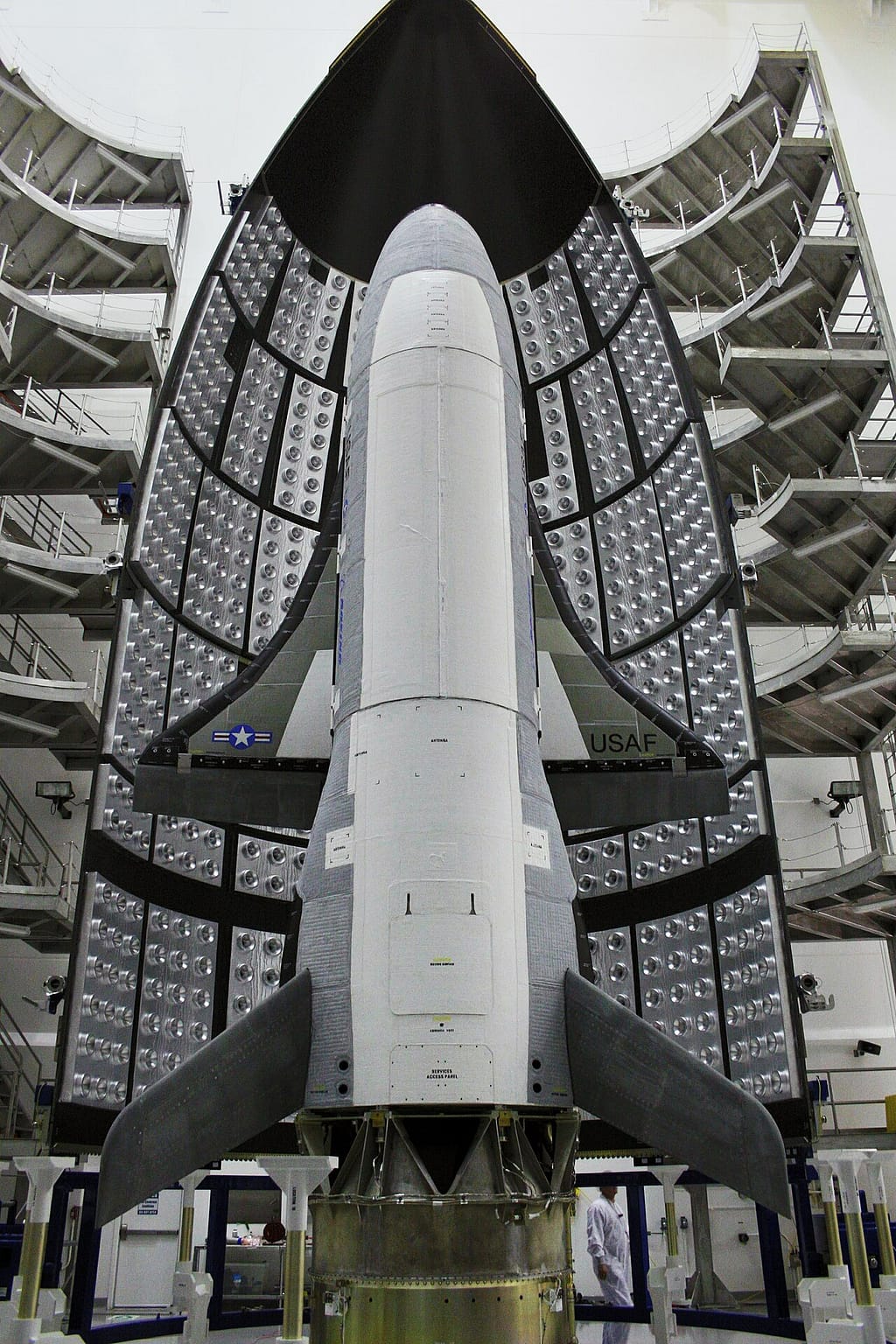 The Boeing X-37B being encapsulated inside its launch fairing