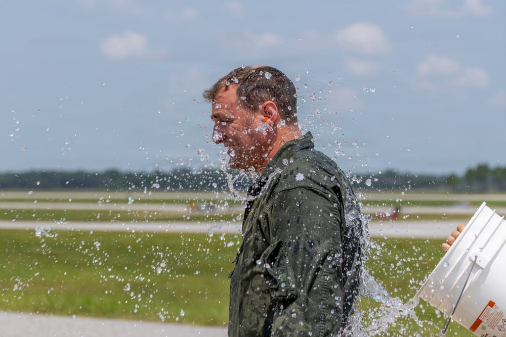 Cmdr. Paul Ingram wetted down after the final C-2A Greyhound flight