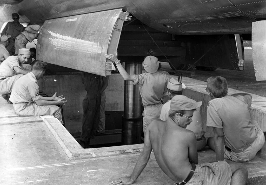 Little Boy being loaded from the pit beneath the Enola Gay on Tinian