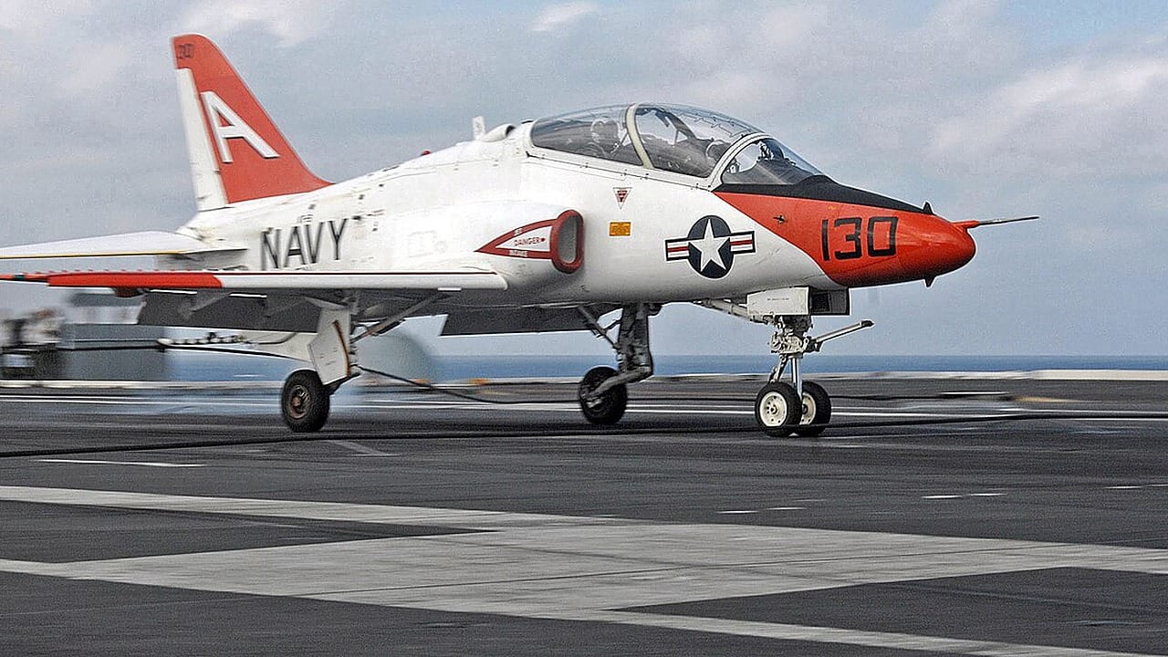 A U.S. Navy T-45C Goshawk jet trainer on an aircraft carrier flight deck
