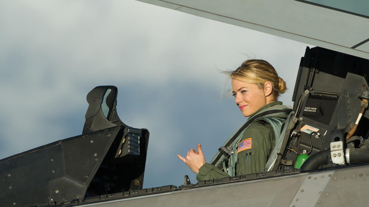 Emma Stone in an F-22 Raptor cockpit during Aloha filming Emma Stone, as Captain Allison Ng, sits in the cockpit of an F-22 Raptor giving the shaka sign during filming of the movie Aloha