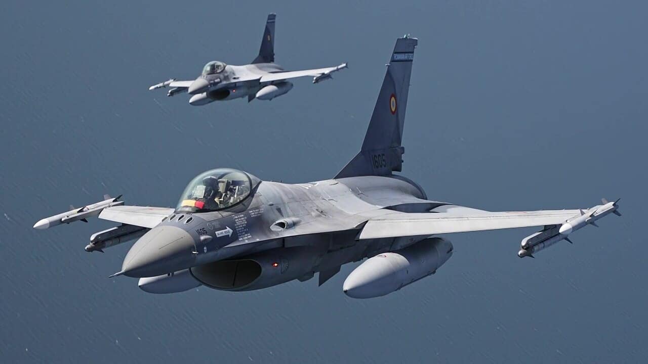 Two Romanian Air Force F-16 Fighting Falcons fly over the Baltic Sea on NATO Baltic Air Policing
