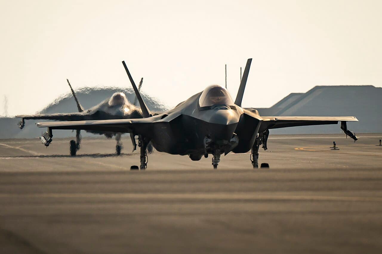 Two F-35A Lightning II fighter jets taxiing at Al Udeid Air Base in Qatar