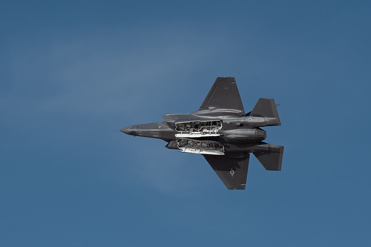 An F-35A Lightning II performing a flying display with weapons bay doors open