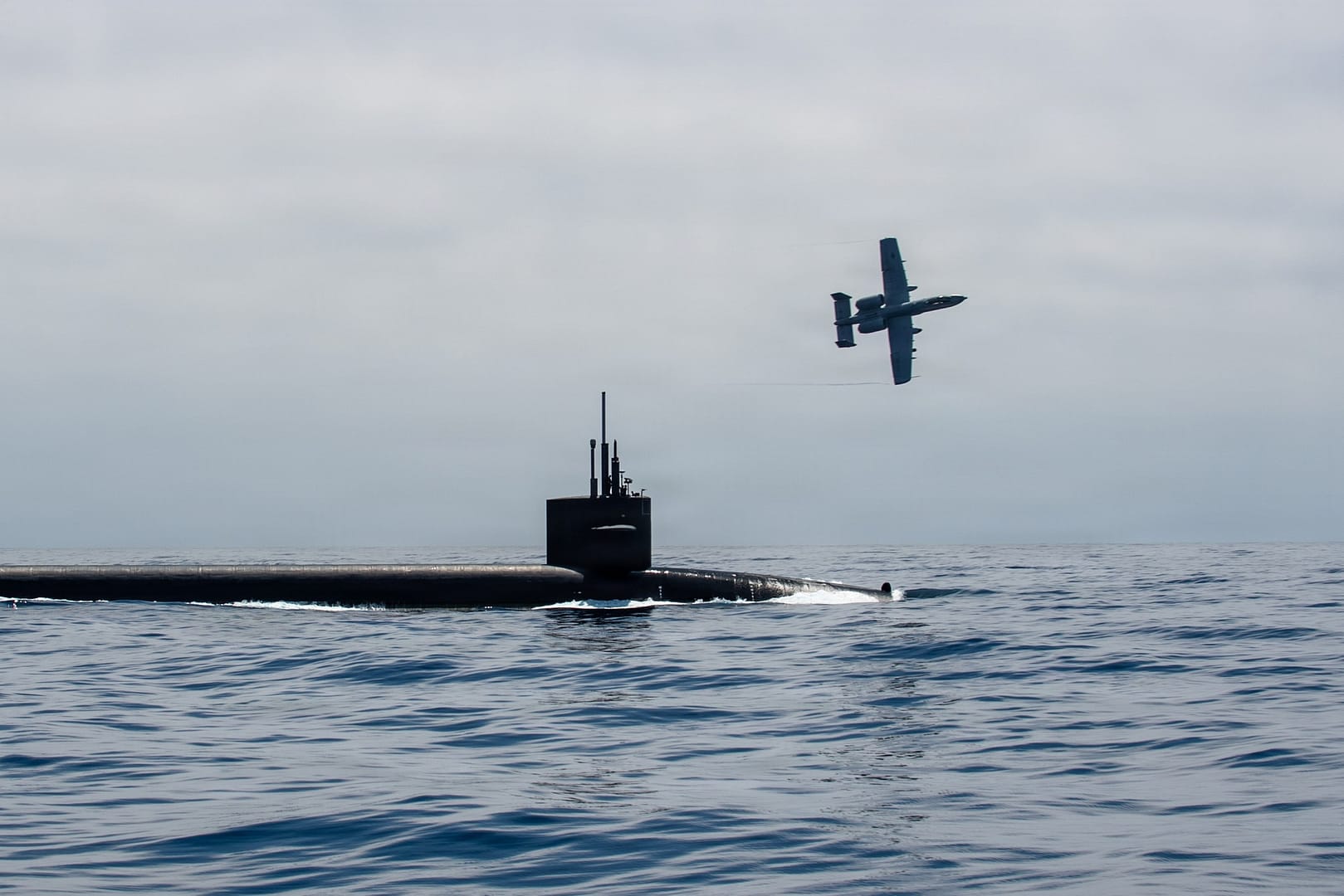 A U.S. Air Force A-10 Thunderbolt II escorts the Ohio-class ballistic missile submarine USS Nebraska in the Pacific