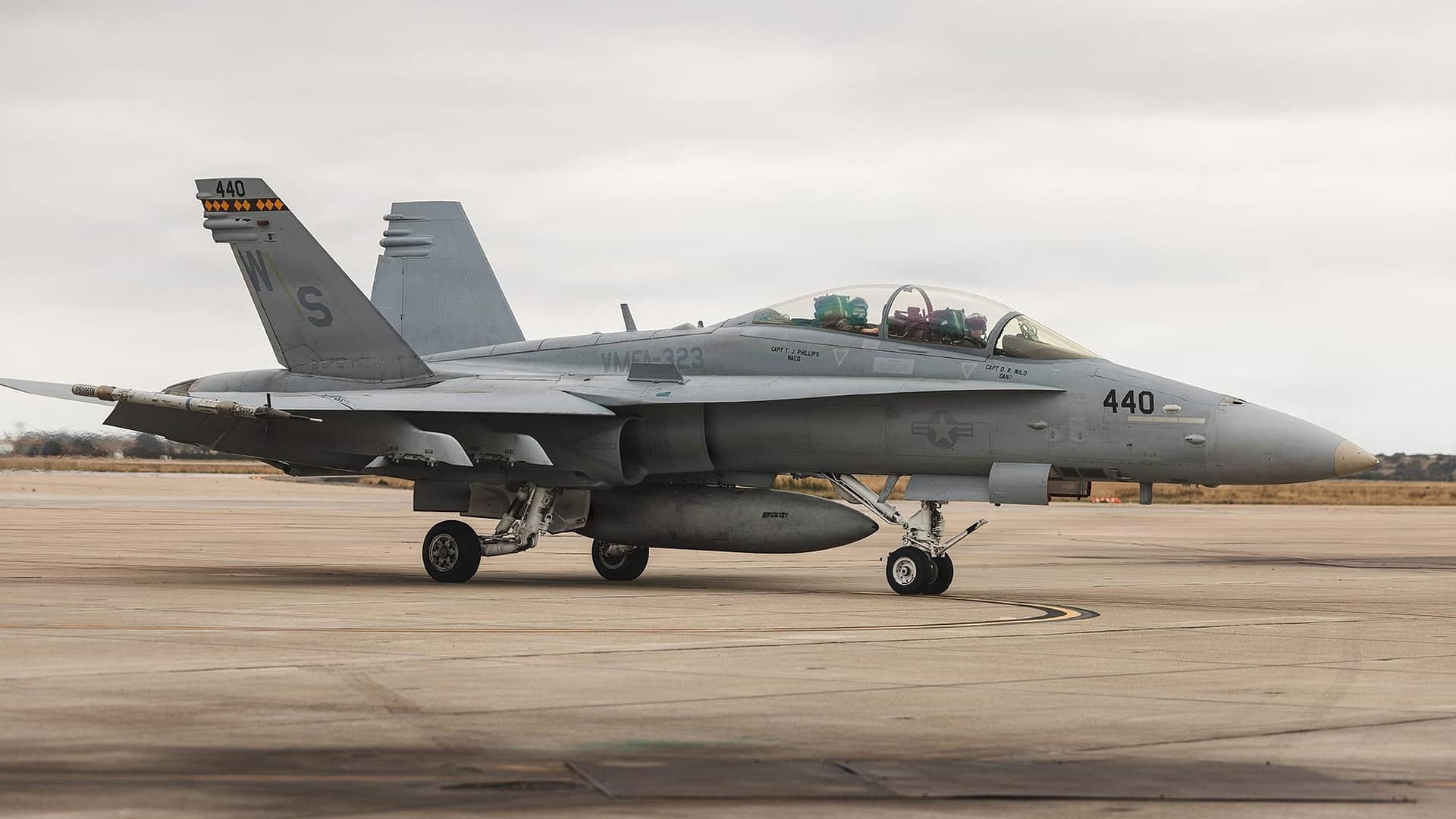 A two-seat VMFA-323 Death Rattlers F/A-18D Legacy Hornet (tail code WS) on the ramp