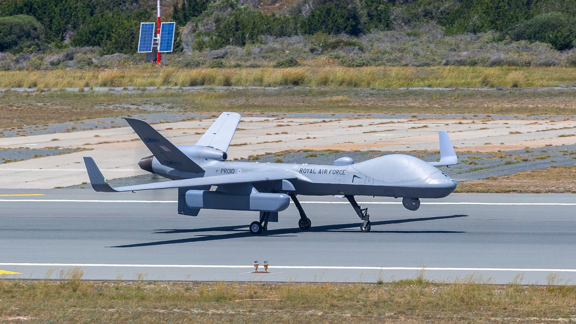 A Royal Air Force Protector RG1 drone on the runway at RAF Akrotiri, Cyprus, carrying an underwing surveillance pod