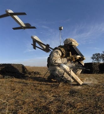 A Switchblade 300 expendable drone launching — DARPA wants hundreds of similar small drones packed into shipping containers