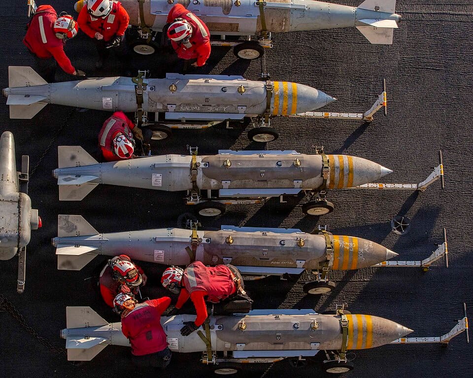 U.S. Navy sailors stage ordnance on the flight deck of USS Abraham Lincoln (CVN 72) during Operation Epic Fury, February 2026