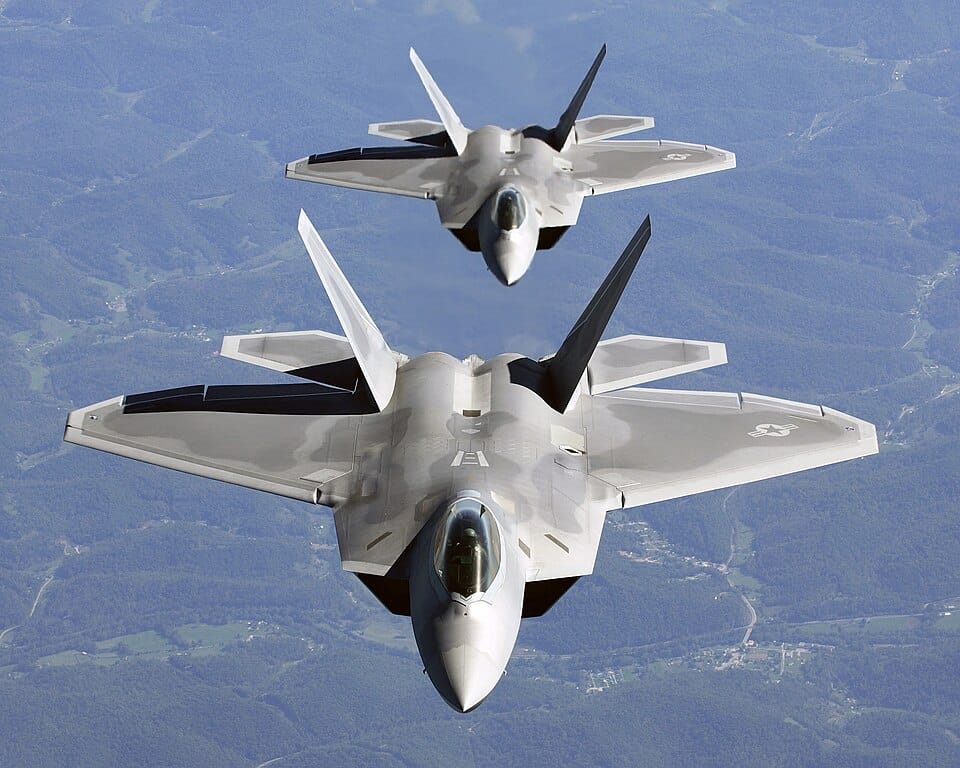 A pair of USAF F-22A Raptors in column flight &mdash; the fighter that won the ATF competition. U.S. Air Force photo