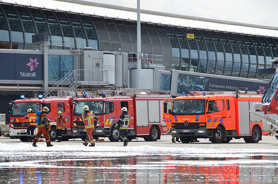 Aircraft emergency drill with fire trucks responding