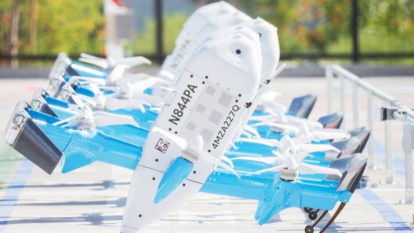 A row of Amazon Prime Air MK30 delivery drones with visible tail registrations