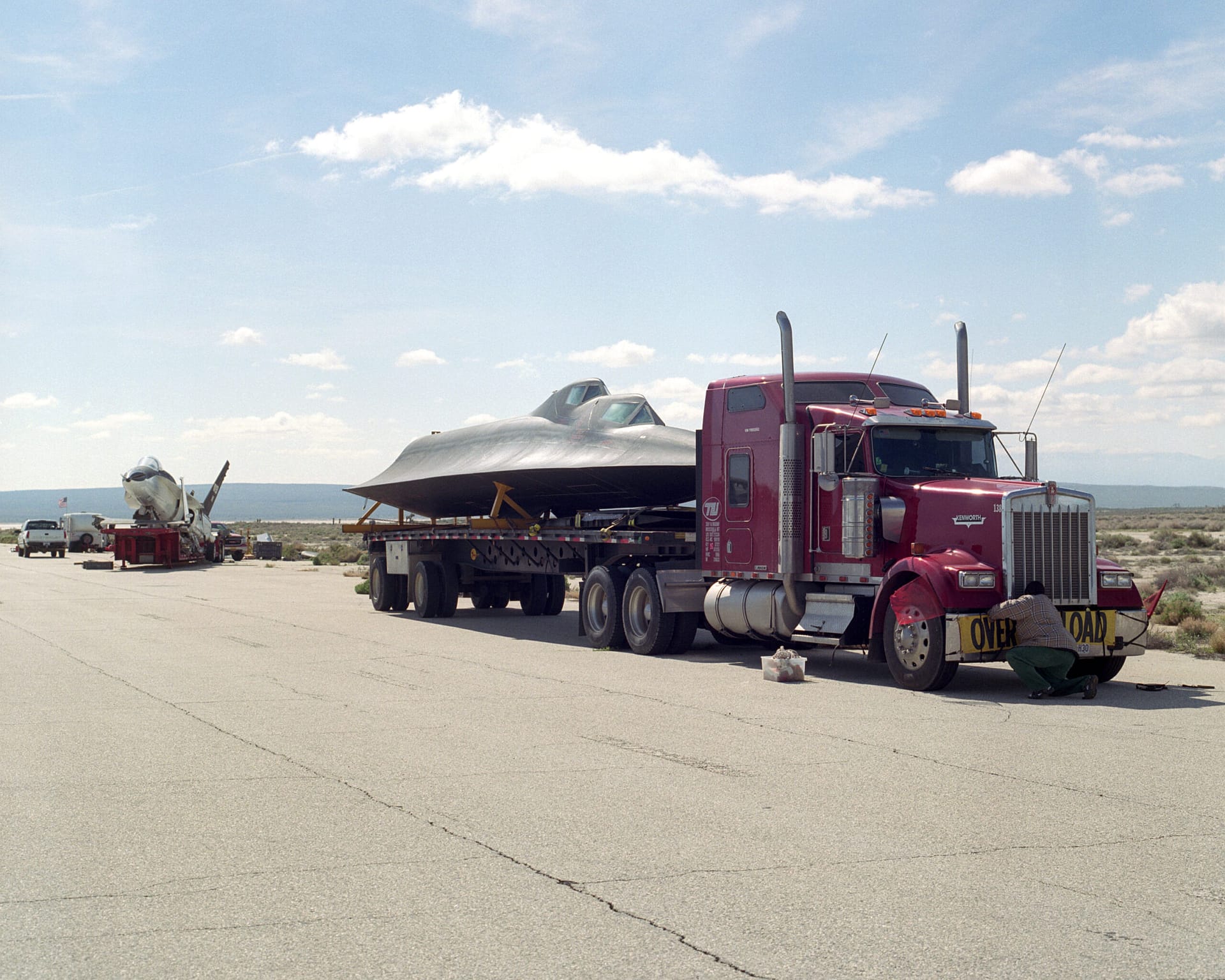 An SR-71 Blackbird fuselage being transported by truck at Edwards Air Force Base