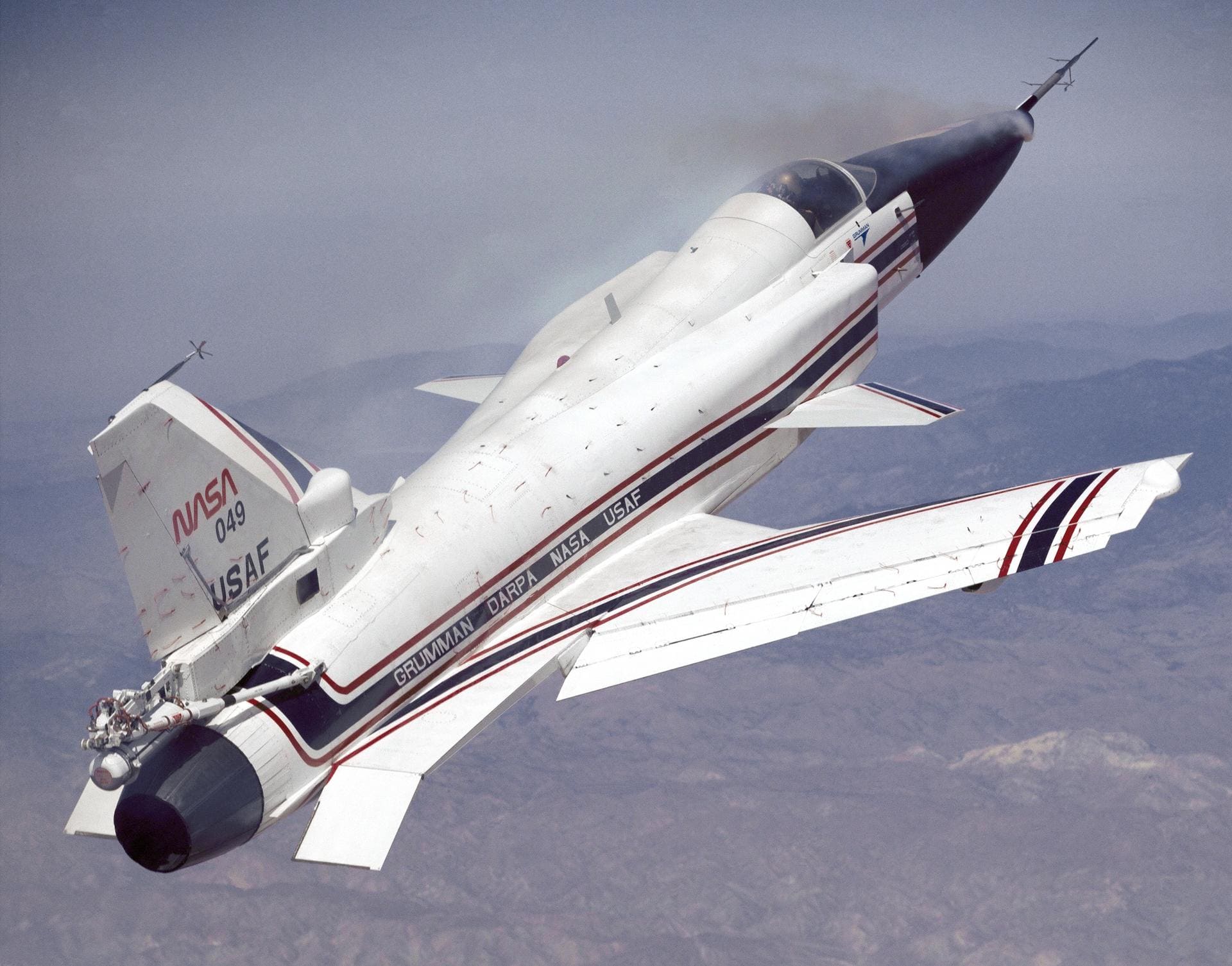 X-29 flying at a high angle of attack with smoke generators showing the airflow