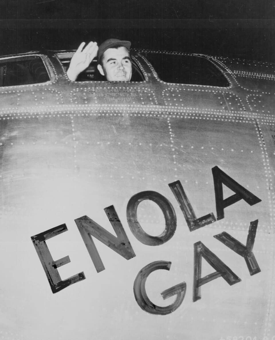 Paul Tibbets waving from the cockpit of the Enola Gay