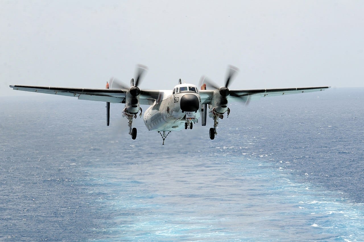 A VRC-40 Rawhides C-2A Greyhound approaches a carrier for landing
