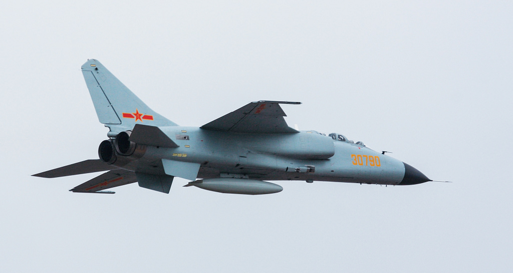 The JH-7A in side profile, showing its long fuselage and shoulder-mounted wing.