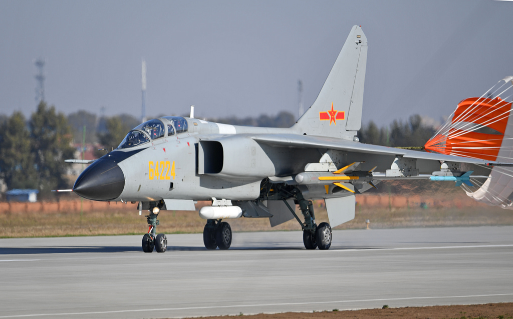 A JH-7A rolling out on the runway with its brake parachute deployed.