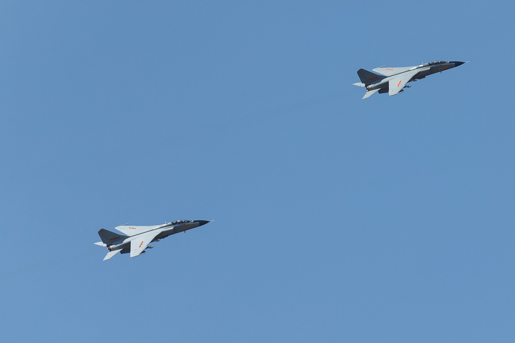 A pair of JH-7A fighter-bombers flying in close formation.