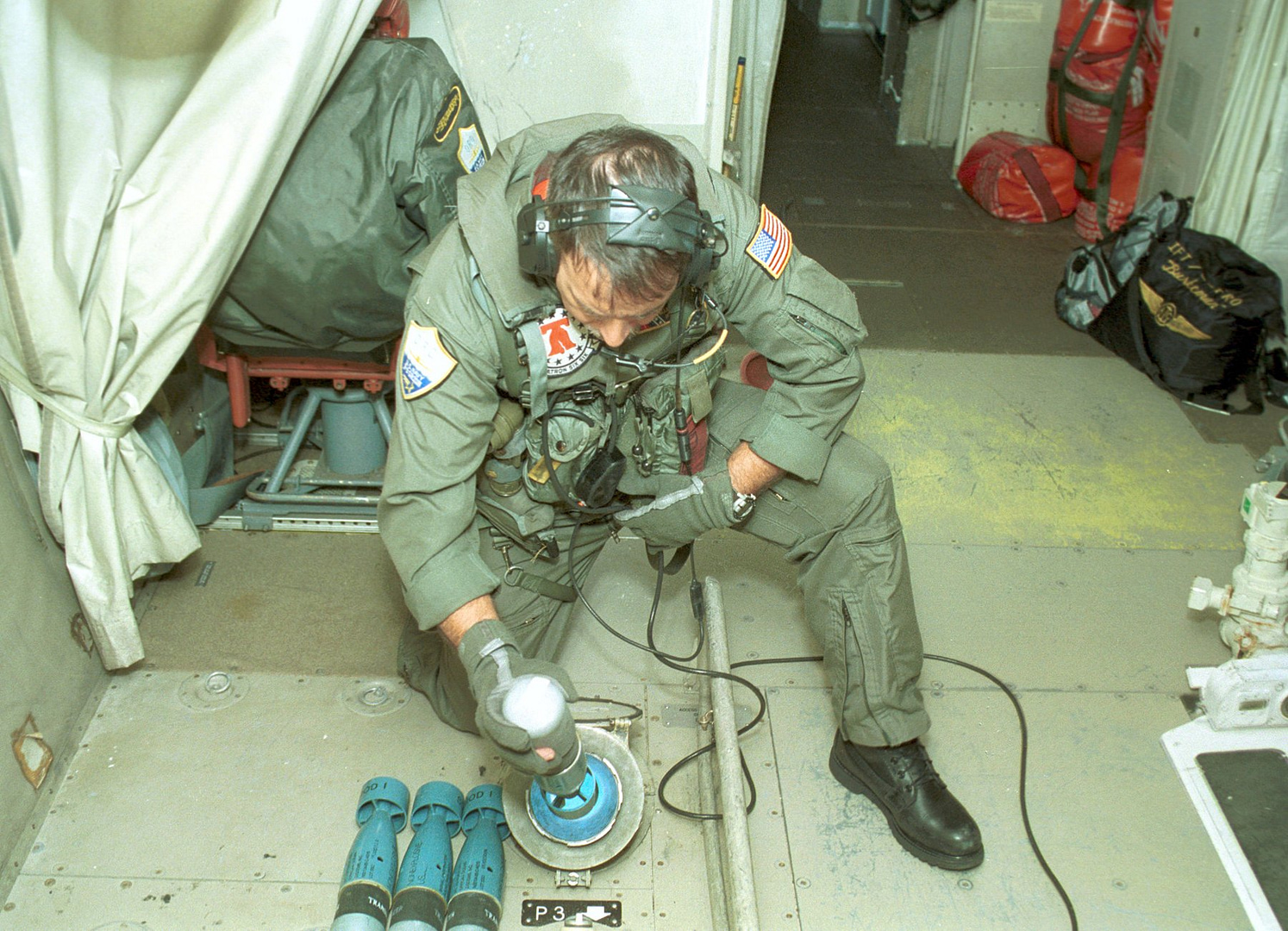 A U.S. Navy ordnanceman loads weapons aboard a P-3C Orion