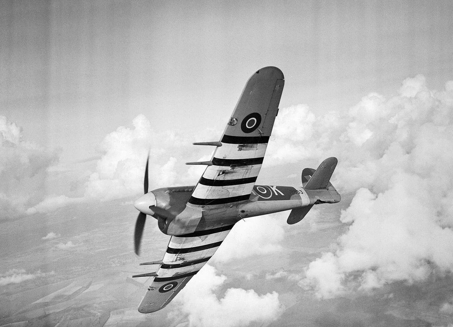 Hawker Typhoon ground-attack fighter with invasion stripes in flight
