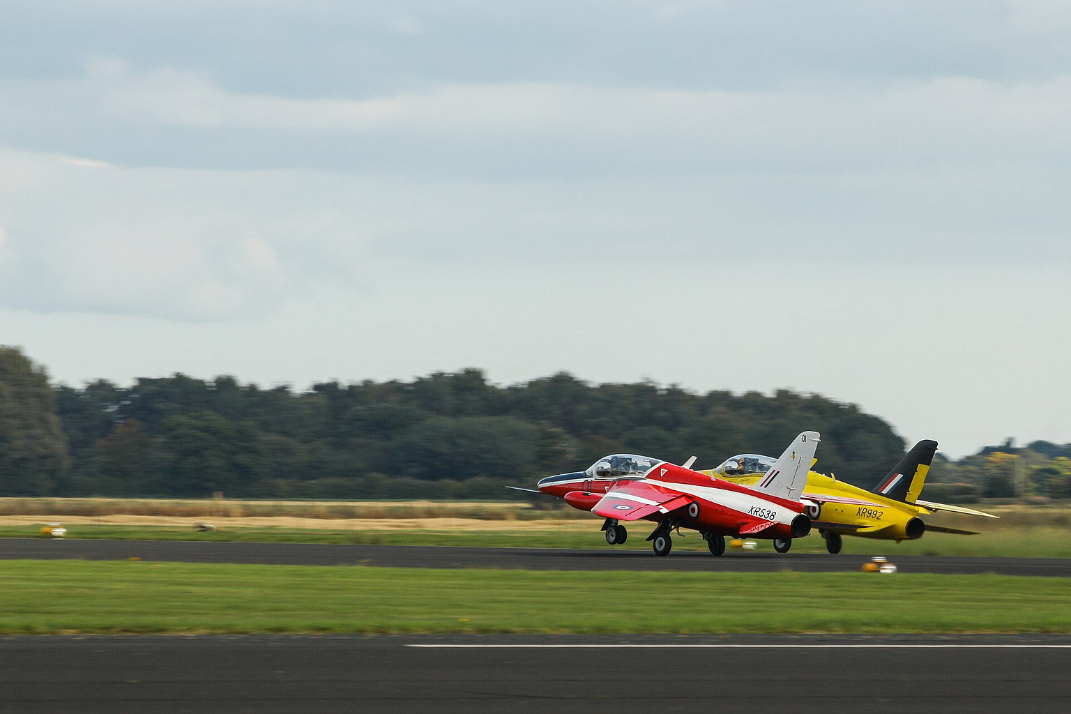 Folland Gnat light jet fighters on the grass in display colours