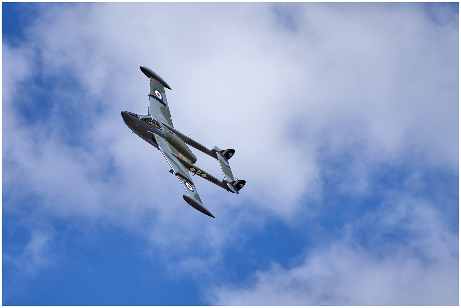 de Havilland Venom twin-boom jet fighter-bomber banking in flight