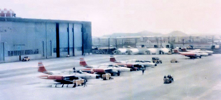 A flightline of Scorpions, showing the straight wing, wingtip pods and twin-jet layout.