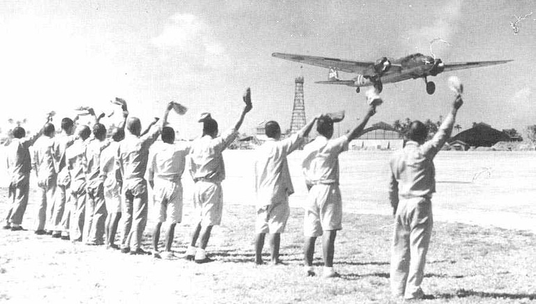 Ground crew wave off a G3M as it departs on a long over-water mission.