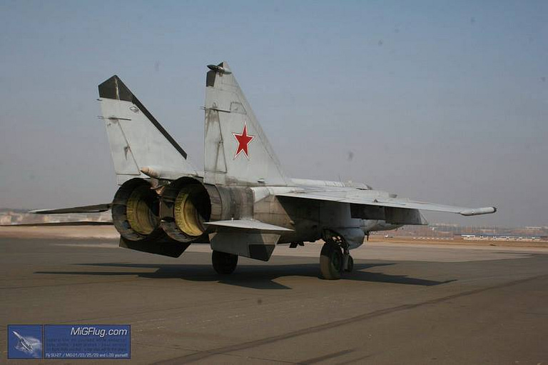 Rear view of a MiG-25 Foxbat showing its twin engine nozzles and red star