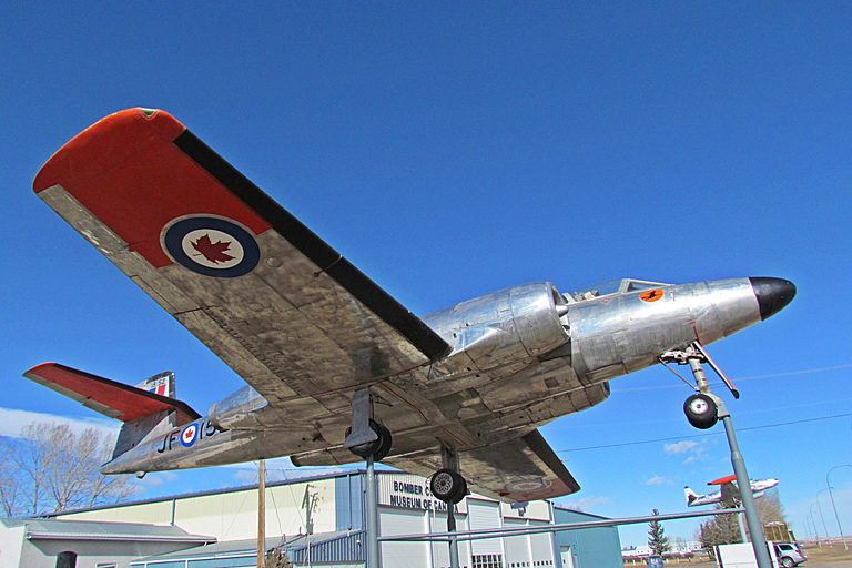 A CF-100 seen from below, showing the straight wing and the wingtip rocket pods.