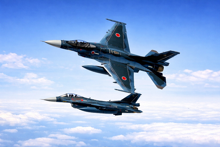 Two F-2s in formation; the blue topside camouflage is built for hunting over water, not for the airshow.