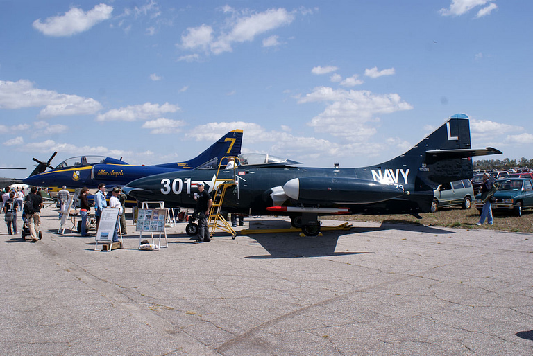 A preserved Blue Angels F9F-5 Panther in its blue-and-gold livery.