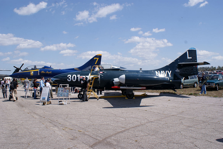 A preserved Blue Angels F9F-5 Panther in its blue-and-gold livery.