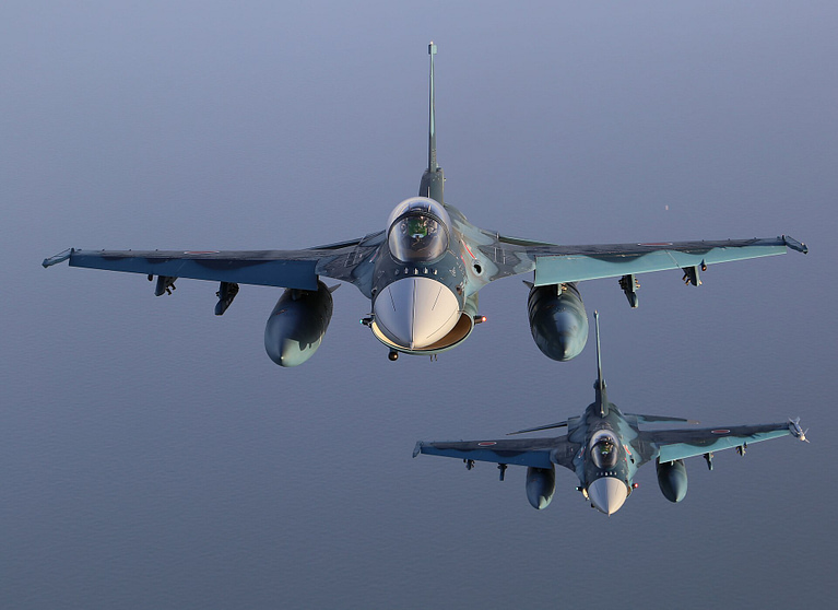 A pair of JASDF F-2s in close formation over the clouds.