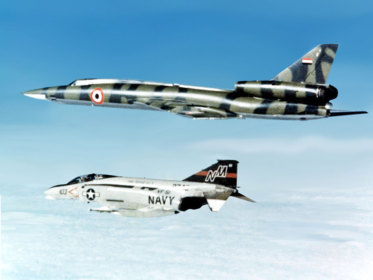 A Libyan Tu-22 Blinder in flight over the Mediterranean, shadowed by a US Navy F-4 Phantom in 1977.