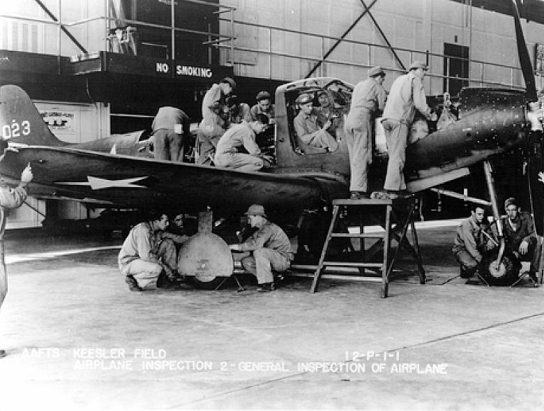 Ground training on a P-39 the car-style doors and nose-wheel gear clearly visible.