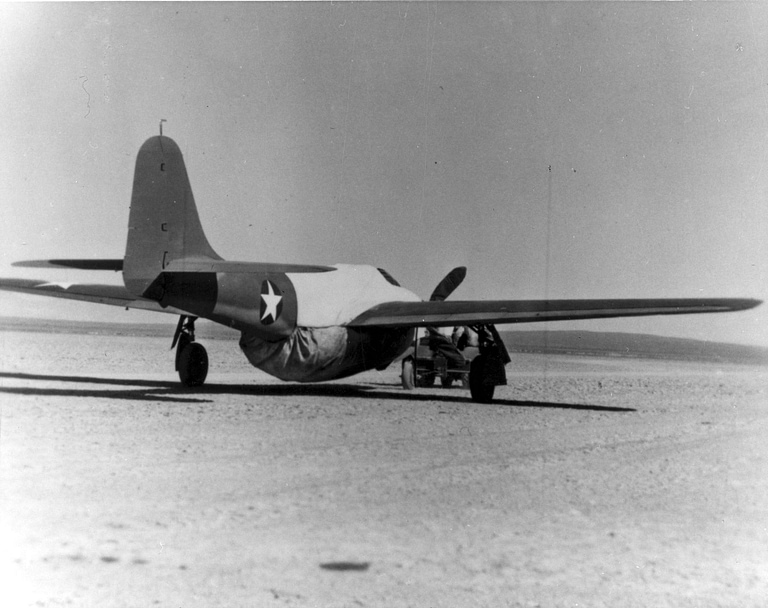 The secret XP-59A prototype at Muroc Dry Lake where a dummy propeller was fitted on the ground to disguise it.
