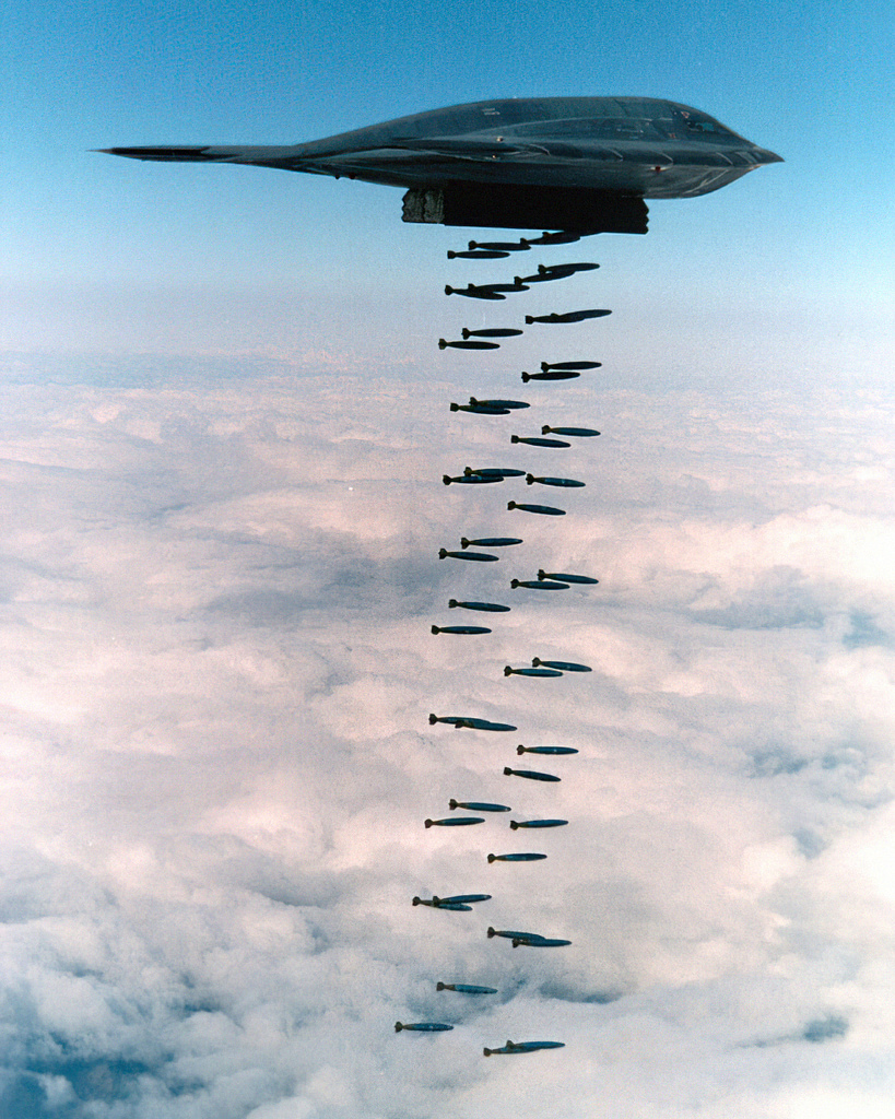 A B-2 releasing bombs during testing its entire payload rides inside two internal bays.