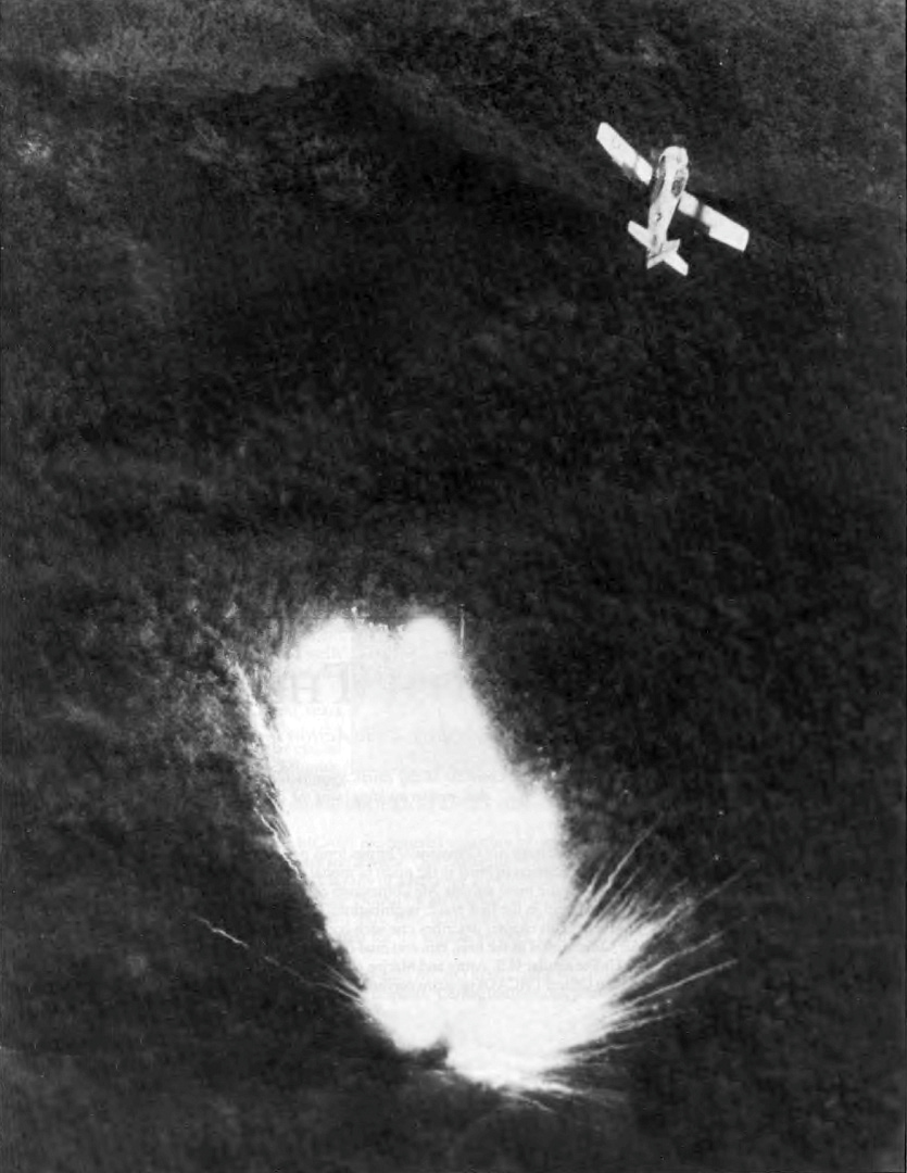 A South Vietnamese Air Force T-28D Trojan releasing napalm during a strike in Southeast Asia.
