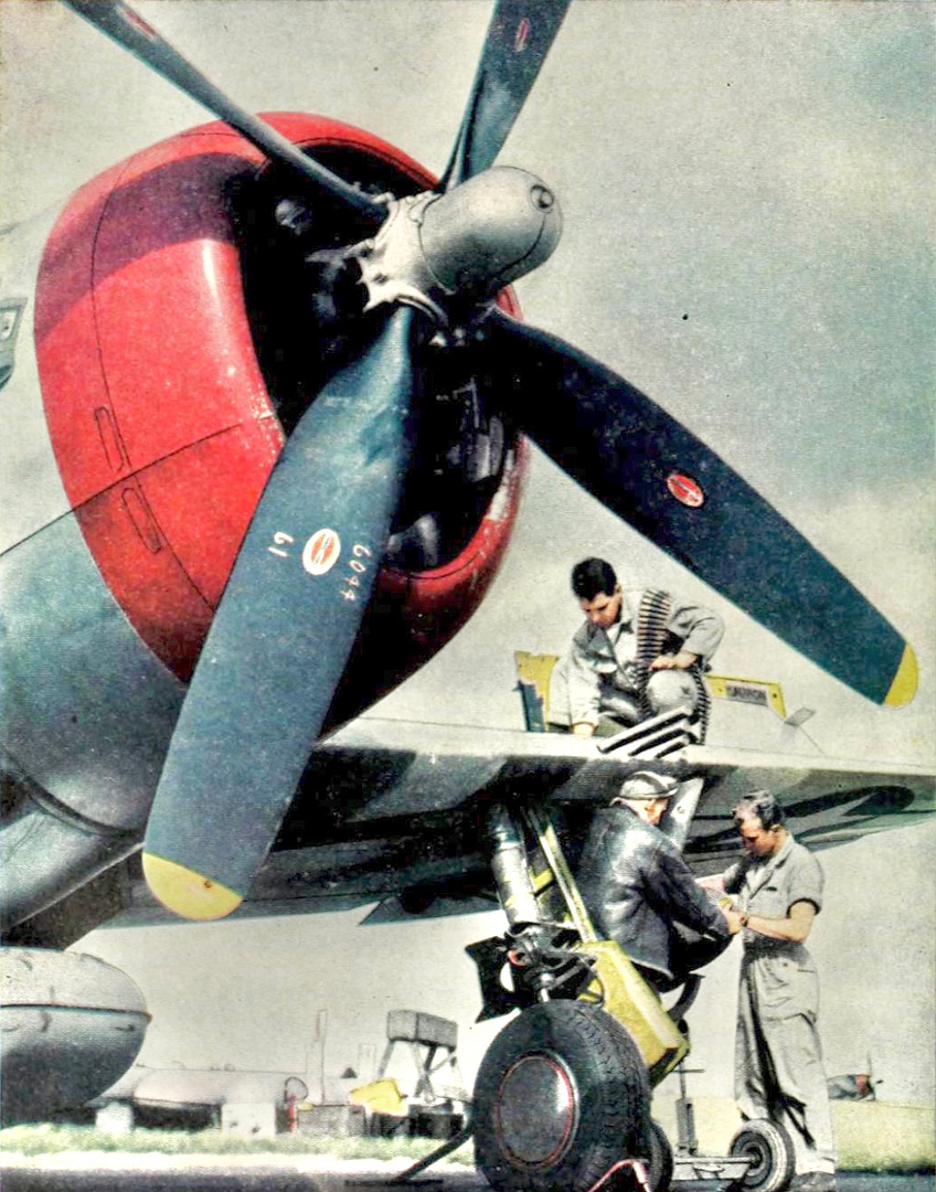 Arming a Thunderbolt: bombs and .50-cal ammunition loaded for a ground-attack sortie.