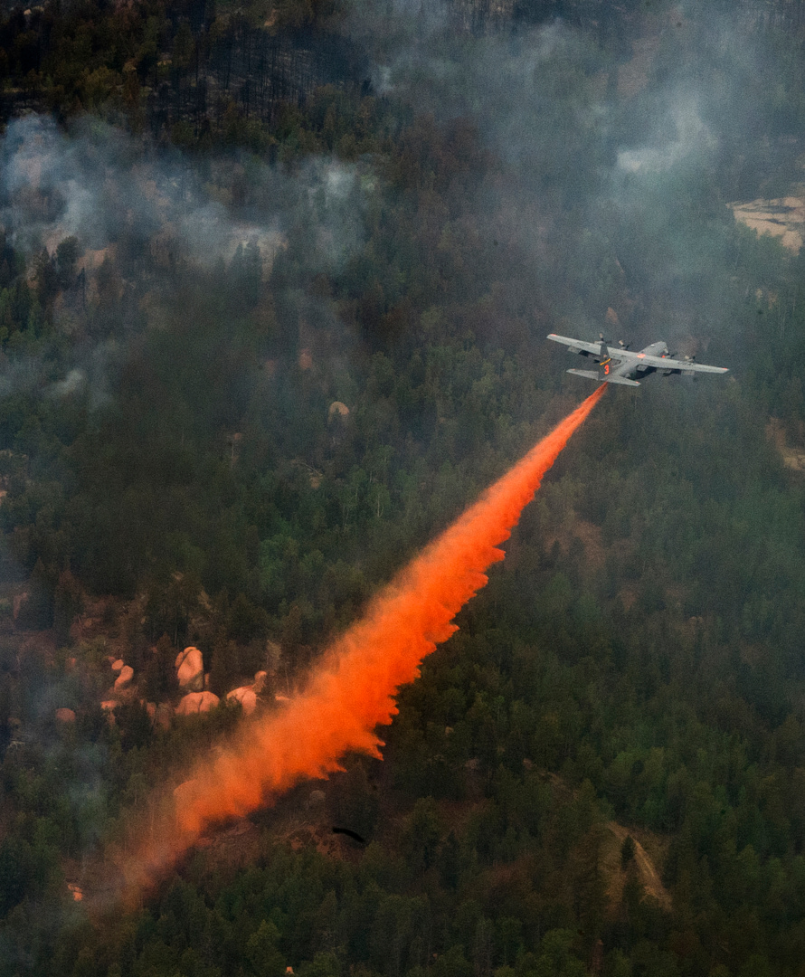 A C-130 Hercules drops fire retardant using the Modular Airborne Fire Fighting System (MAFFS) over the Waldo Canyon fire.
