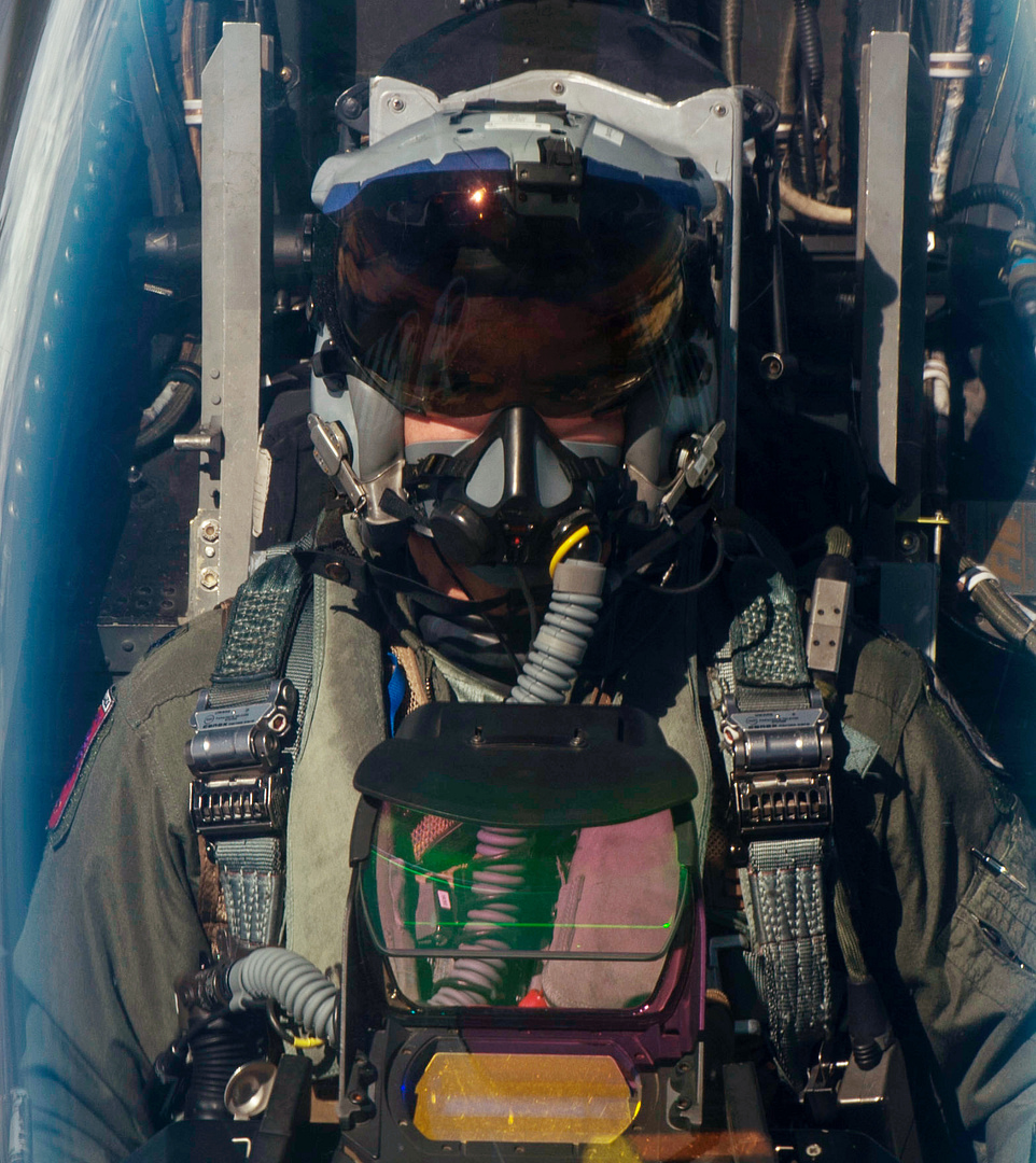 Inside the F-16 cockpit bubble canopy, sidestick and a reclined ejection seat.