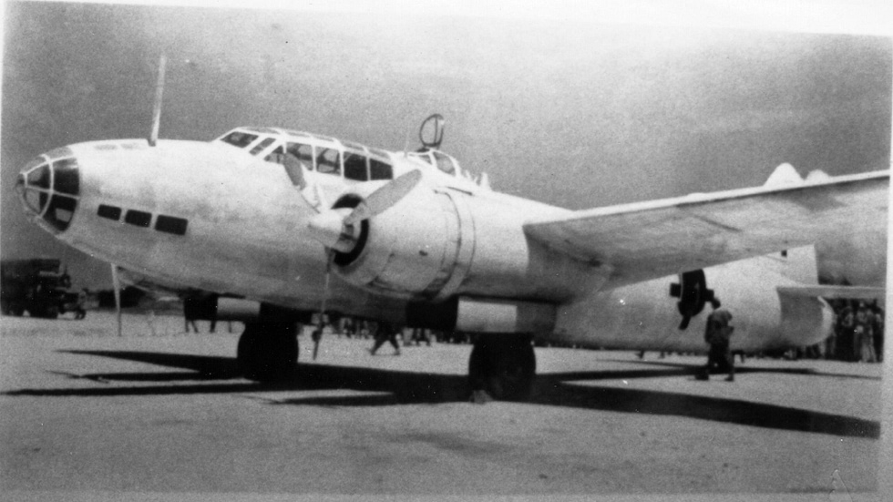 A G4M painted white with green crosses the surrender-delegation markings of August 1945.