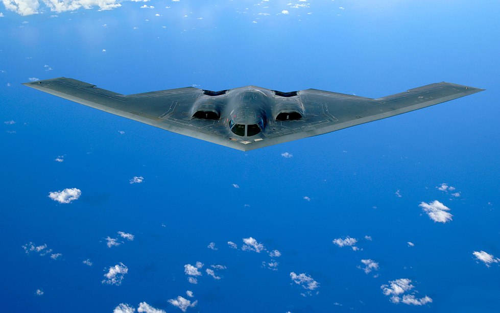 A B-2 Spirit banking in flight the tailless flying wing that gave stealth its shape.