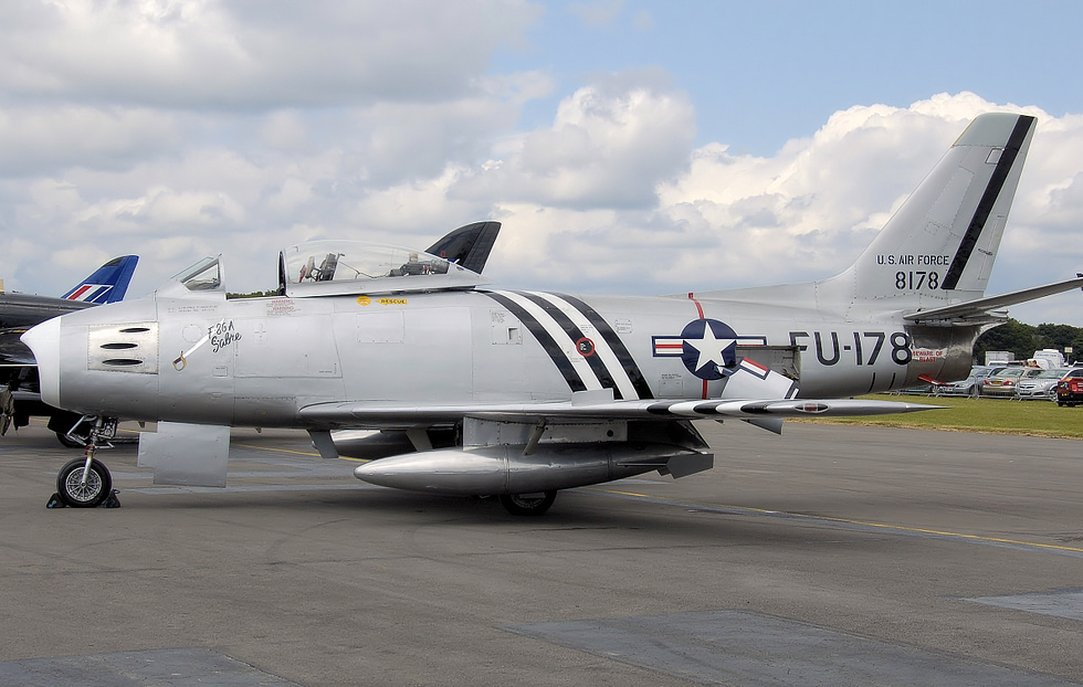 A bare-metal F-86 Sabre warbird at an airshow a handful remain airworthy in private hands.