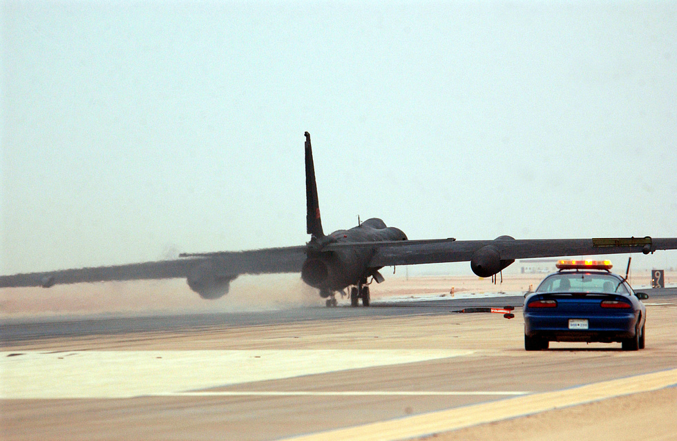 A chase car races down the runway behind a landing U-2 the types signature ritual.